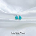 Teal teardrop earrings on a white satin background with 'Precious Lifetime Memories by Annabel' branding.