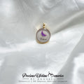 Jewelry pendant with a butterfly design on a white fabric background, featuring 'Precious Lifetime Memories by Annabel'.