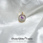 Jewelry pendant with a butterfly design on a white fabric background, featuring 'Precious Lifetime Memories by Annabel'.