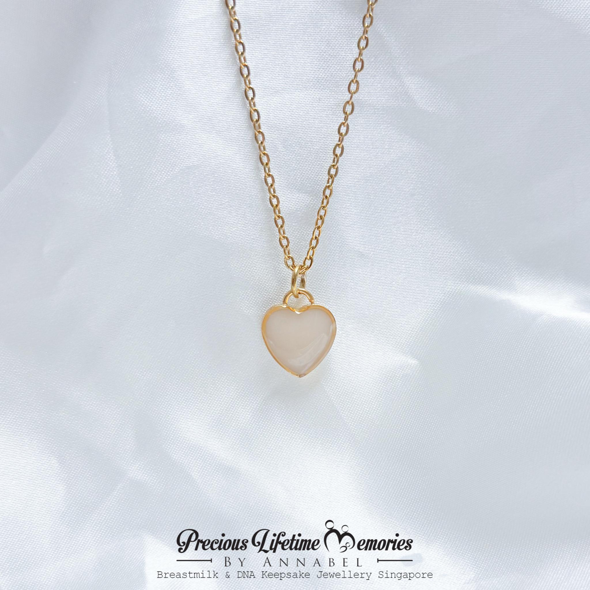 Heart-shaped pendant necklace on a white background with 'Precious Lifetime Memories by Annabel' branding.