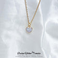 Gold necklace with a heart-shaped pendant on a white fabric background, 母乳项链