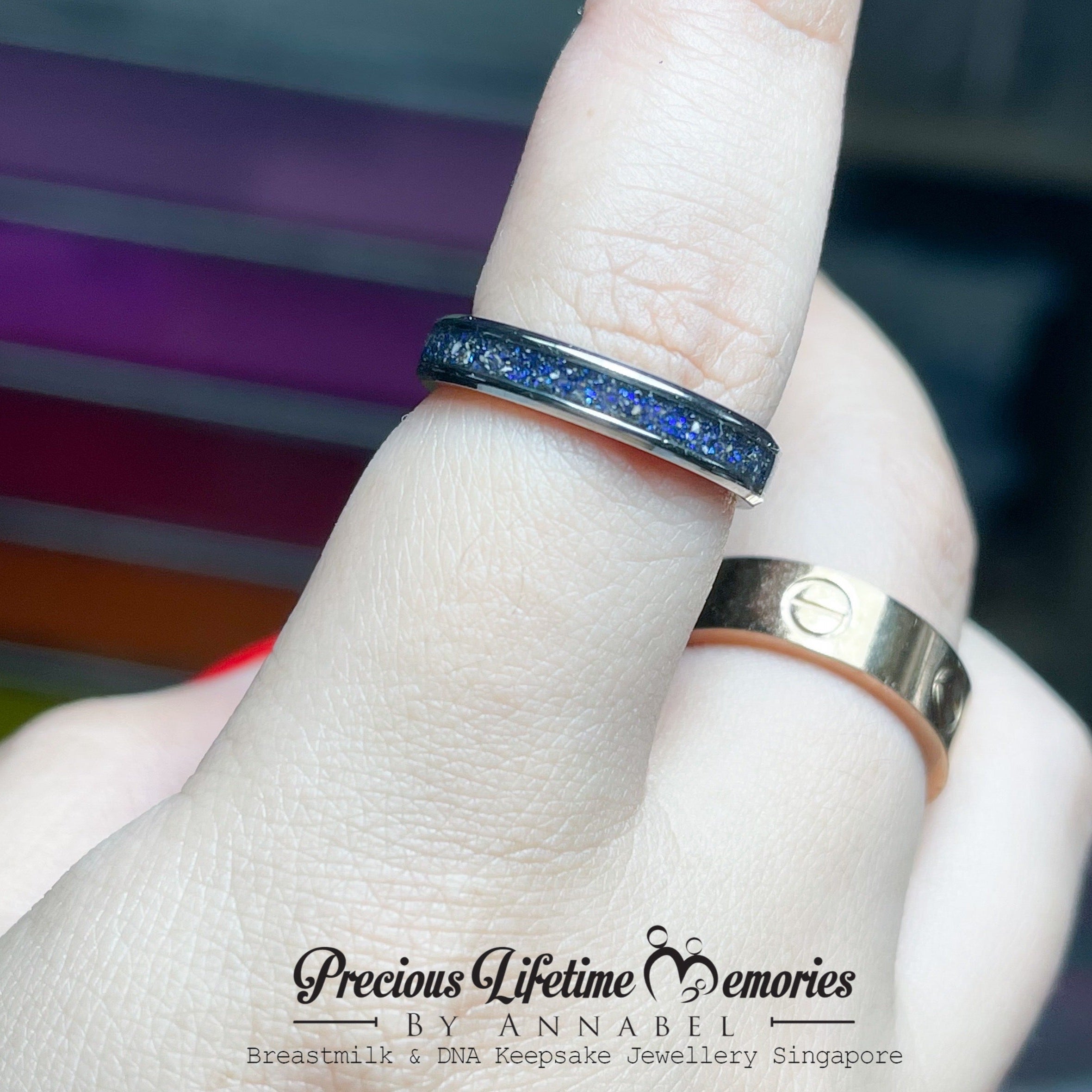 Two rings on a finger with a blurred background and 'Precious Lifetime Memories by Annabel' branding.