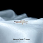 Rose gold ring with a heart-shaped gemstone on a white fabric background, branded 'Precious Lifetime Memories by Annabel'.