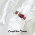 Ring with red inlay on a white fabric background, featuring 'Precious Lifetime Memories by Annabel' branding.