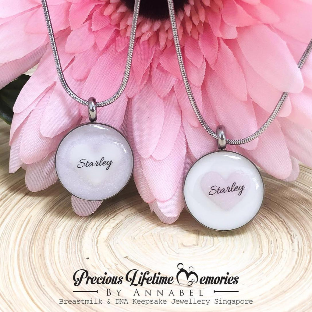 Two necklaces with 'Starley' engraved on them, displayed against a pink flower background.