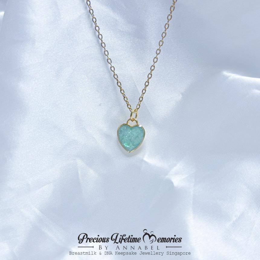 Necklace with a heart-shaped green pendant on a white background, branded 'Precious Lifetime Memories by Annabel'.