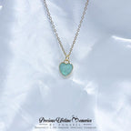 Necklace with a heart-shaped green pendant on a white background, branded 'Precious Lifetime Memories by Annabel'.