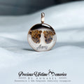 Pendant with a unique design on a white fabric background, featuring the brand 'Precious Lifetime Memories by Annabel'.