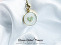 Jewelry pendant with heart design on a white fabric background, featuring 'Precious Lifetime Memories by Annabel'.