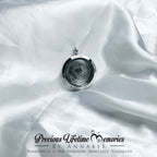 Necklace with a locket on white fabric, featuring 'Precious Lifetime Memories by Annabel'.