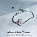Silver bracelet with a pink gemstone on a light gray background, featuring 'Precious Lifetime Memories by Annabel'.