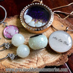 Jewelry set including necklaces and earrings on a wooden surface with 'An En Bin' engraved.