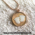Necklace with a round pendant featuring cloud designs on a white fur background