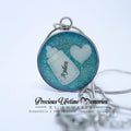 Necklace with pendant featuring a bottle and heart design on a light blue background Ayden. Breast milk keepsake singapore