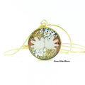 Necklace with a round pendant featuring a white flower design on a gold and silver background.