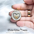 Heart-shaped breastmilk pendant held in a hand with 'Precious Lifetime Memories by Annabel' branding.