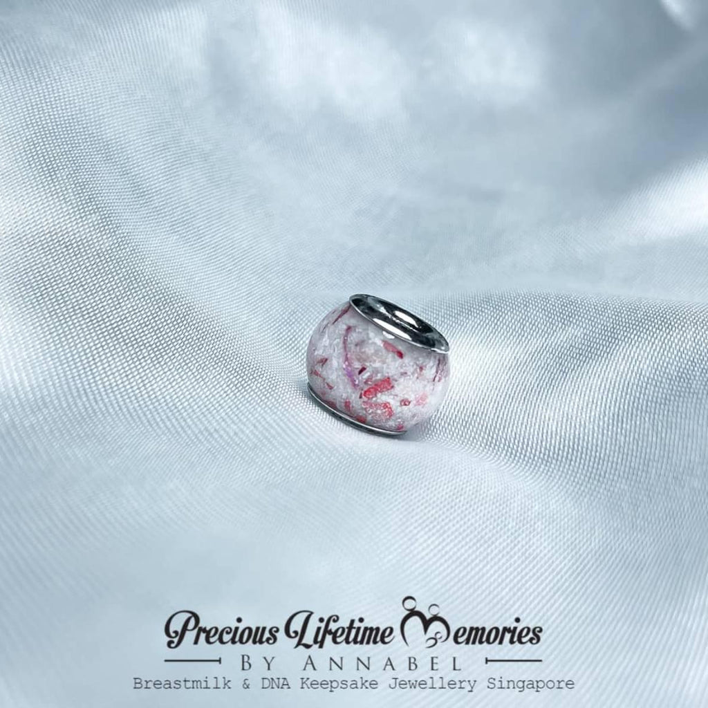Silver charm with pink marbled design memorial cremation ashes, featuring 'Precious Lifetime Memories by Annabel' branding.