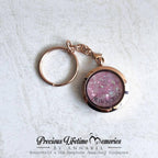 Rose gold keychain with pink glittery cremation pet ashes on a white textured background, branded 'Precious Lifetime Memories by Annabel'.