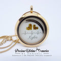 Gold locket with heart-shaped objects and 'Kyler' engraved, branded 'Precious Lifetime Memories by Annabelle'.