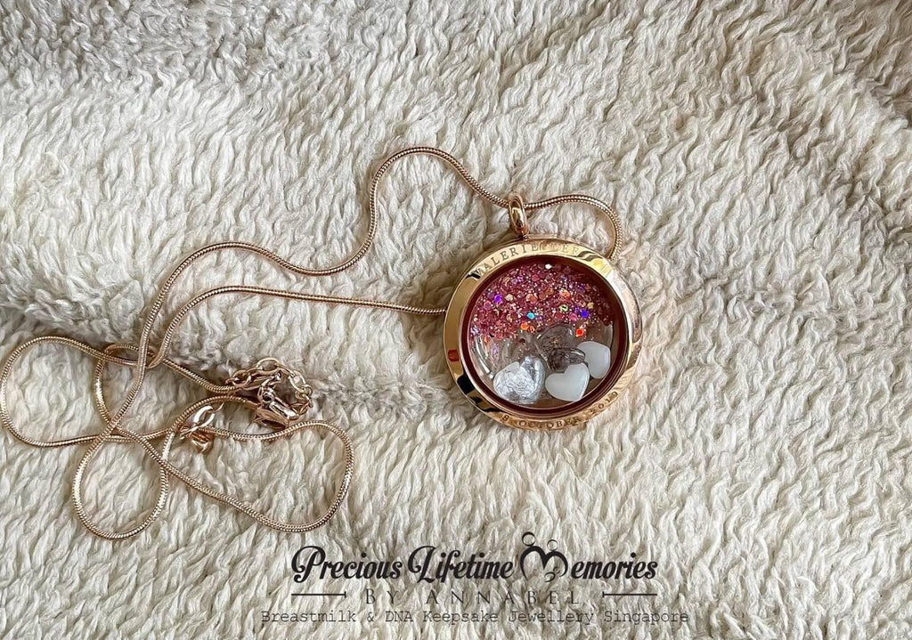 Rose gold locket with decorative elements on a textured white surface, featuring 'Precious Lifetime Memories' text.