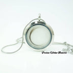 Silver locket with chain on a white background, featuring 'Precious Lifetime Memories' text.