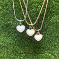 Three heart-shaped pendants on necklaces against a green grass background with 'Precious Lifetime Memories' text.