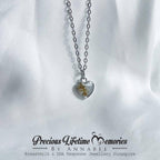Heart-shaped necklace with a clear pendant on a white fabric background, featuring 'Precious Lifetime Memories by Annabel'.
