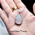 Teardrop-shaped pendant with glittery design held in a hand, branded 'Precious Lifetime Memories by Annabel'.