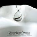 Teardrop-shaped pendant on a white satin background with 'Precious Lifetime Memories by Annabel' branding.
