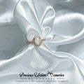 Ring with a central gemstone on white satin fabric, featuring 'Precious Lifetime Memories by Annabel' branding.