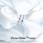 Jewelry set with blue gemstone on white fabric, branded 'Precious Lifetime Memories by Annabel'.