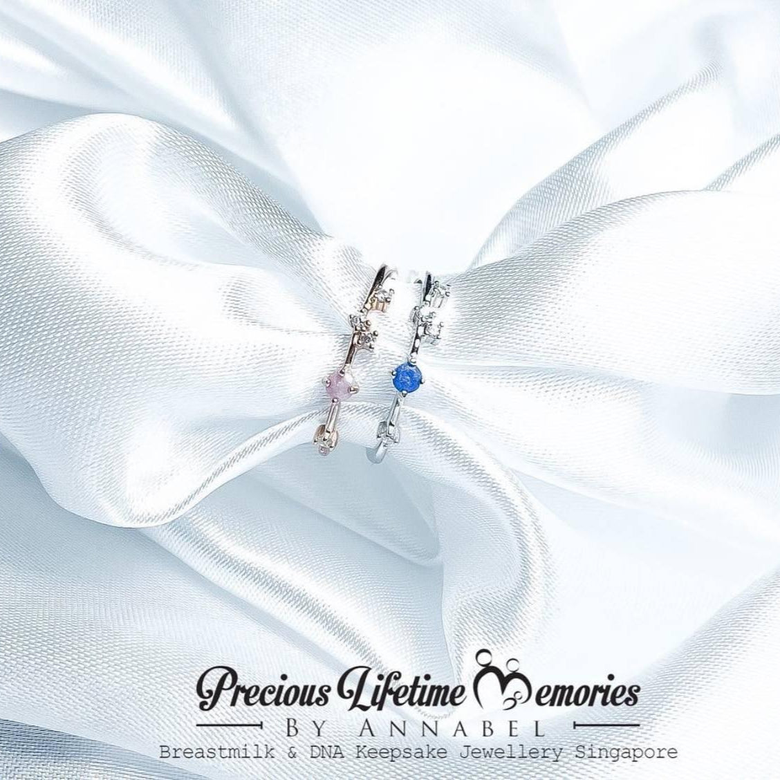 Jewelry set with blue gemstone on white fabric, branded 'Precious Lifetime Memories by Annabel'.