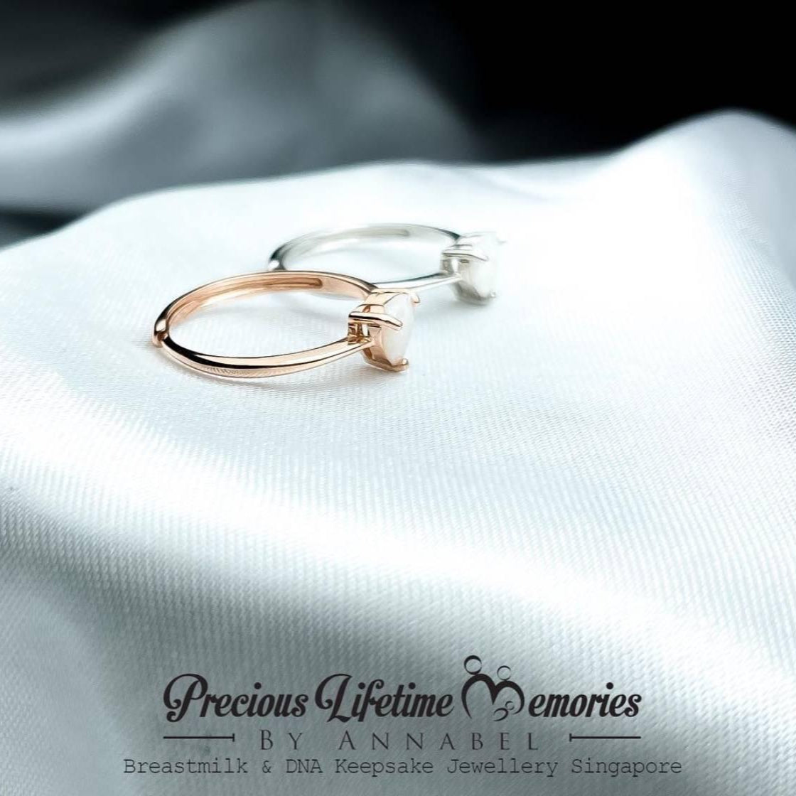 Gold hoop earrings on a white fabric with 'Precious Lifetime Memories by Annabel' branding.