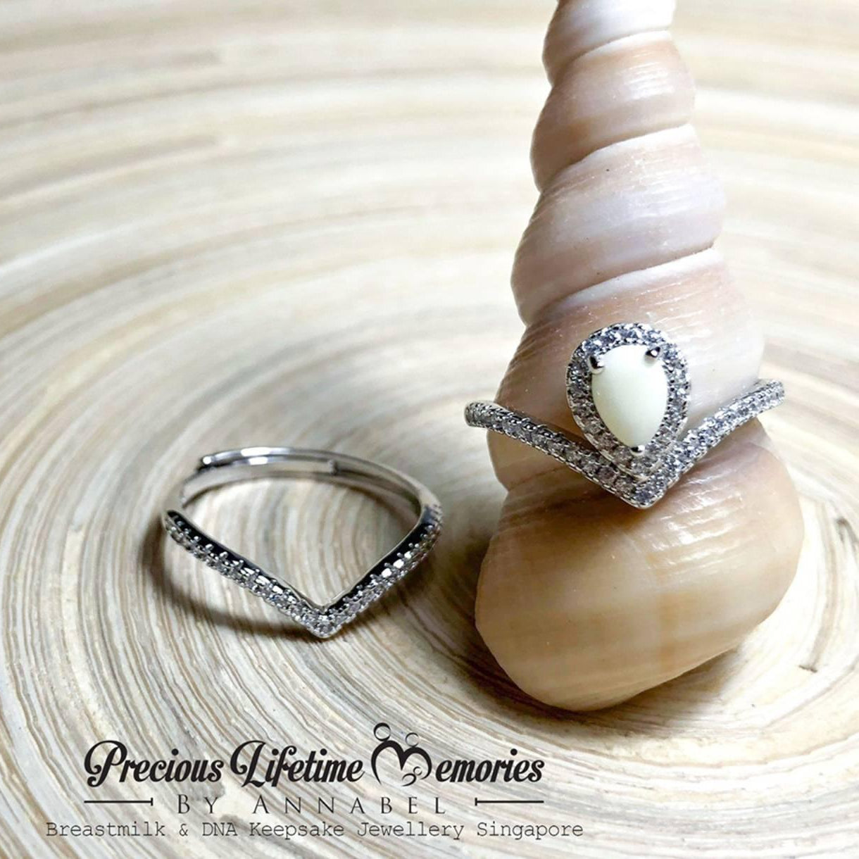 Two rings on a shell with 'Precious Lifetime Memories by Annabel' branding.