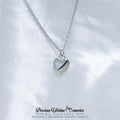 Heart-shaped necklace pendant on a white fabric background with 'Precious Lifetime Memories by Annabel' branding.