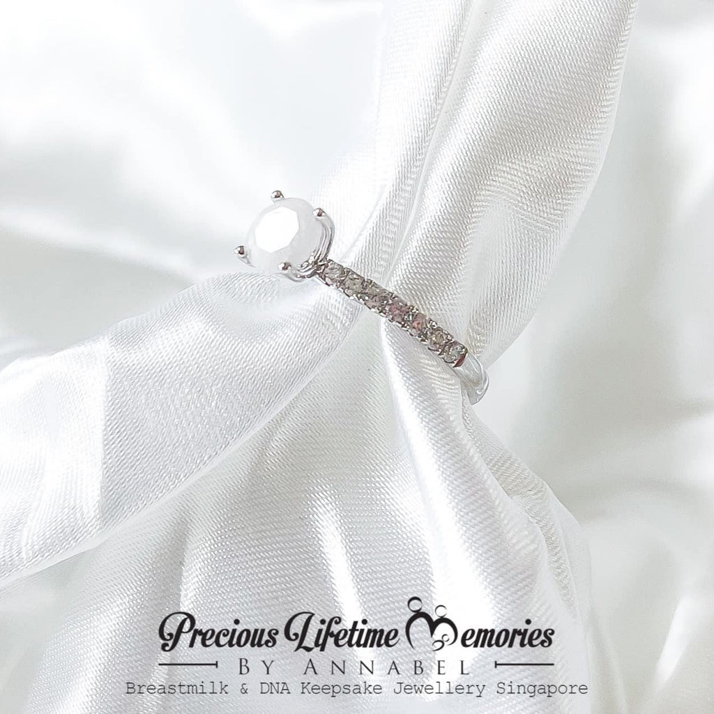 Silver bracelet on a white fabric background with 'Precious Lifetime Memories by Annabel' branding.