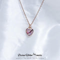 Heart-shaped necklace with a pink center on a white background, branded 'Precious Lifetime Memories by Annabel'.
