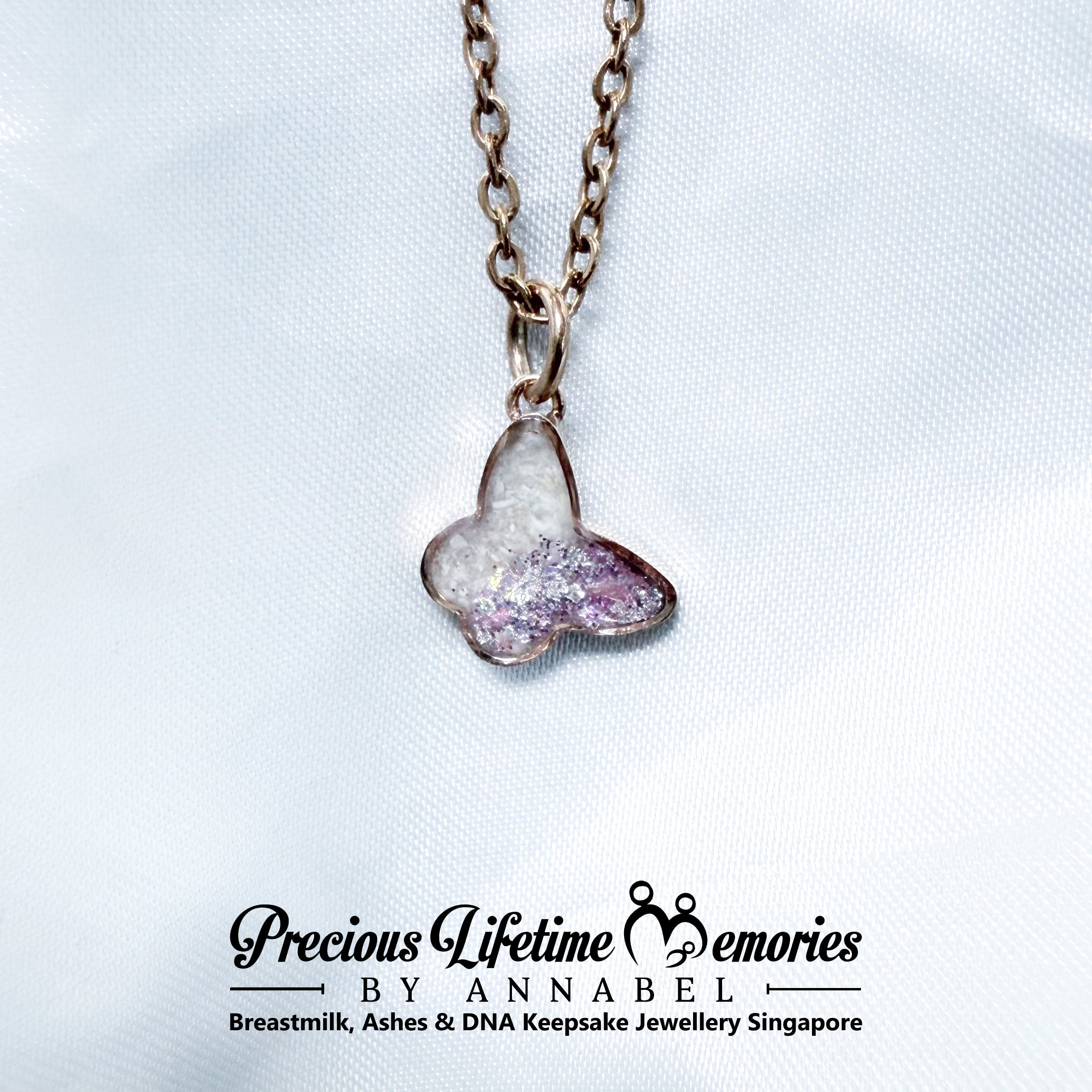 Heart-shaped with pets cremation ashes pendant on a chain with 'Precious Lifetime Memories by Annabel' branding.