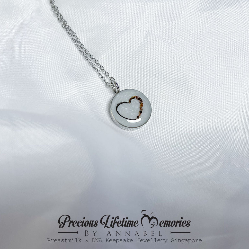 Silver necklace with a heart-shaped pendant on a white background, featuring 'Precious Lifetime Memories by Annabel'.