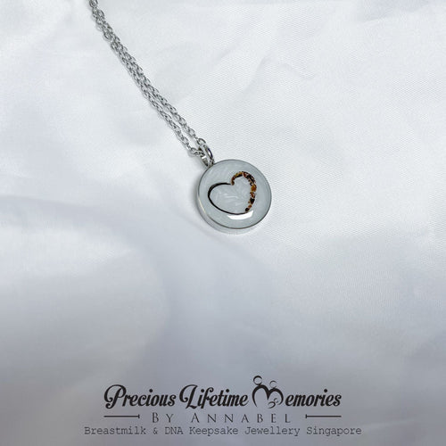 Silver necklace with a heart-shaped pendant on a white background, featuring 'Precious Lifetime Memories by Annabel'.