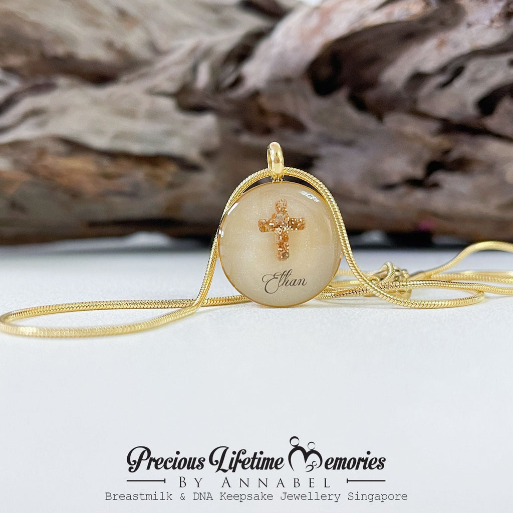 Necklace with a pendant featuring engraved text on a white surface with driftwood in the background.