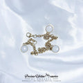 Gold chain breastmilk bracelet with round pendants on a white fabric background, featuring 'Precious Lifetime Memories by Annabel' branding.