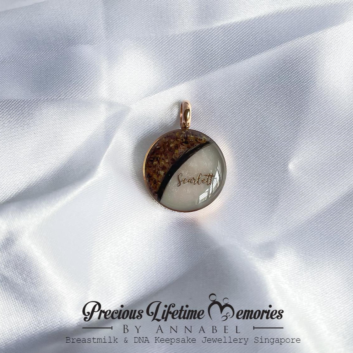 Jewelry pendant on white fabric with 'Previous Lifetime Memories by Annabel' branding.