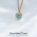 Heart-shaped necklace with gold chain on a white background, featuring 'Keepsake by Annabel'.