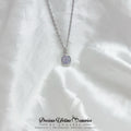 Necklace with a purple pendant on a white fabric background, featuring the brand 'Precious Lifetime Memories by Annabel'.