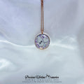Necklace with a round pendant on a white satin background, featuring the brand 'Keepsake Singapore'.